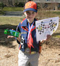 cub scout holding pinewood derby trophy