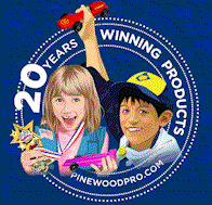 boy and girl pinewood derby winner with trophy
