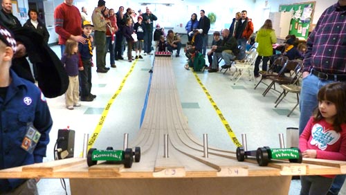 Sandy Hook tribute cars on a pinewood derby track