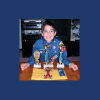 pinewood derby winner with trophies picture