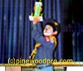 cub scout holding pinewood derby trophy