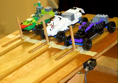 derby cars made from LEGO® bricks on pinewood derby track