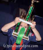 cub scout looking at trophy