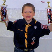 cub scout winner with two trophies