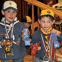 cub scouts with ribbons at their pinewood derby race